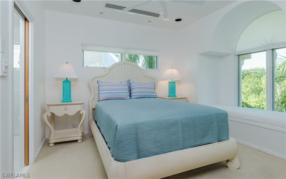 591 Rum Road Captiva, FL 33924 - Photo 16 of 34 a bedroom with a bed and a lamp