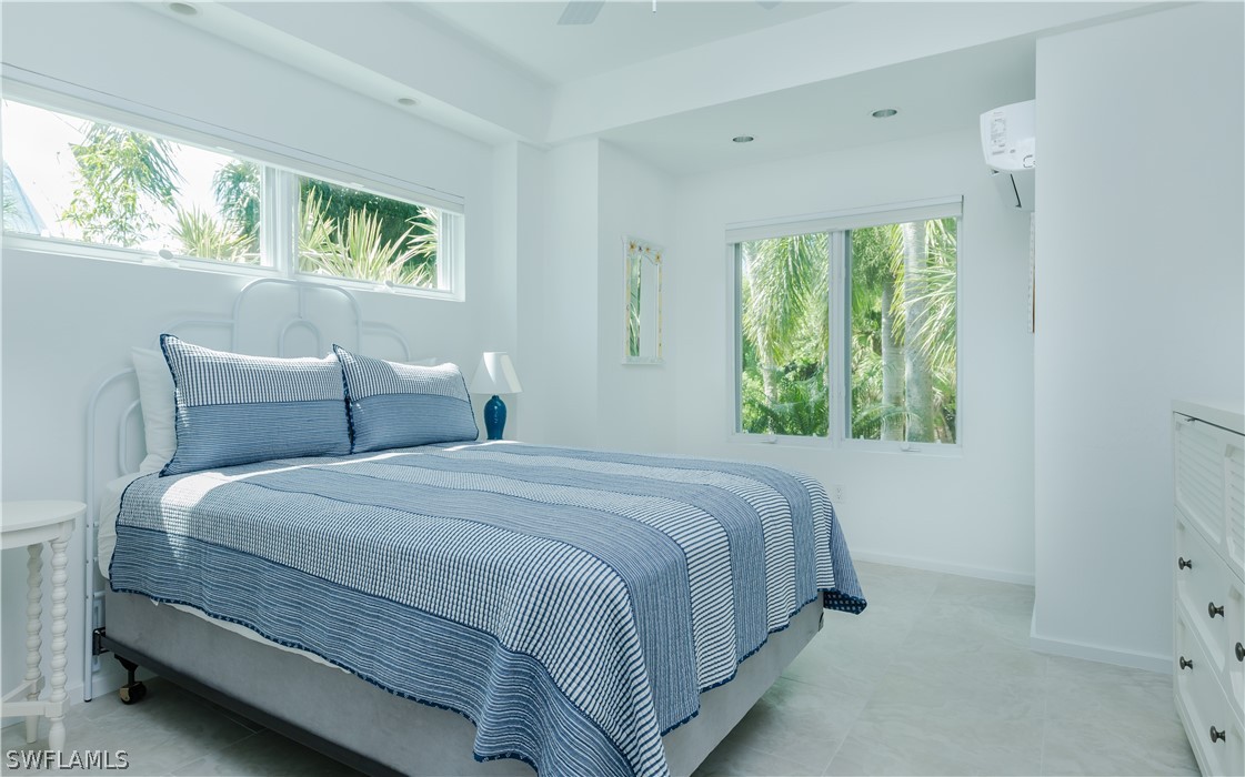 591 Rum Road Captiva, FL 33924 - Photo 21 of 34 a bedroom with a bed and window