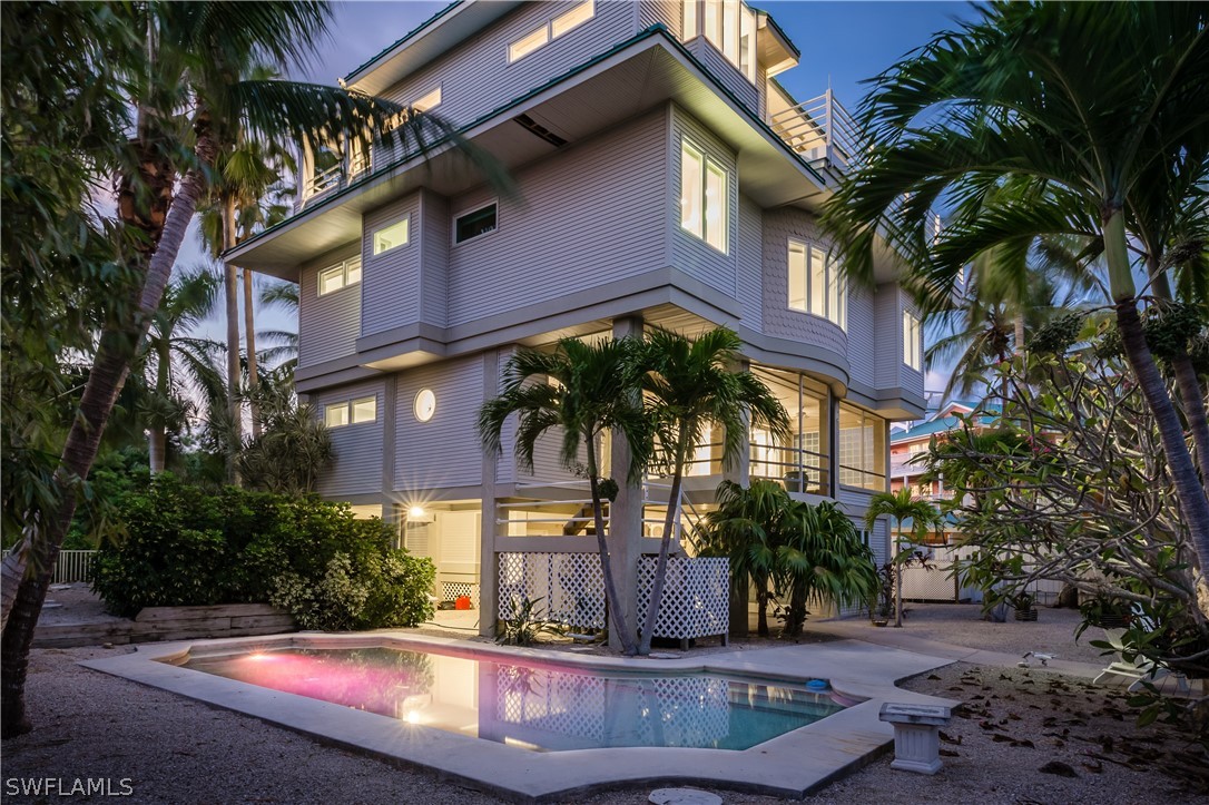 591 Rum Road Captiva, FL 33924 - Photo 30 of 34 a view of a building with a yard