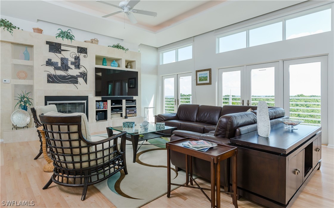 591 Rum Road Captiva, FL 33924 - Photo 3 of 34 a living room with furniture a fireplace and a large window