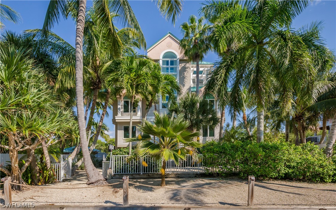 591 Rum Road Captiva, FL 33924 - Photo 32 of 34 a front view of a multi story residential apartment building with a yard