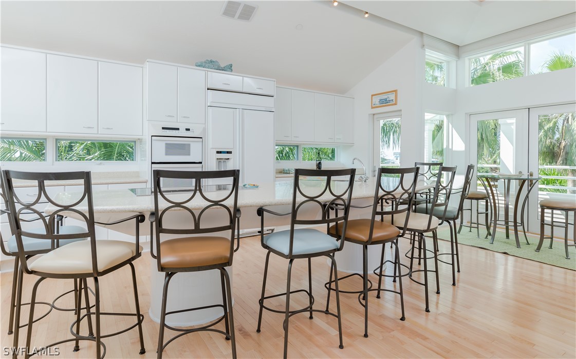 591 Rum Road Captiva, FL 33924 - Photo 7 of 34 a view of a dining room with furniture and wooden floor