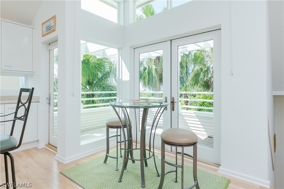 591 Rum Road Captiva, FL 33924 - Photo 8 of 34 a view of a dining room with furniture a chandelier and wooden floor