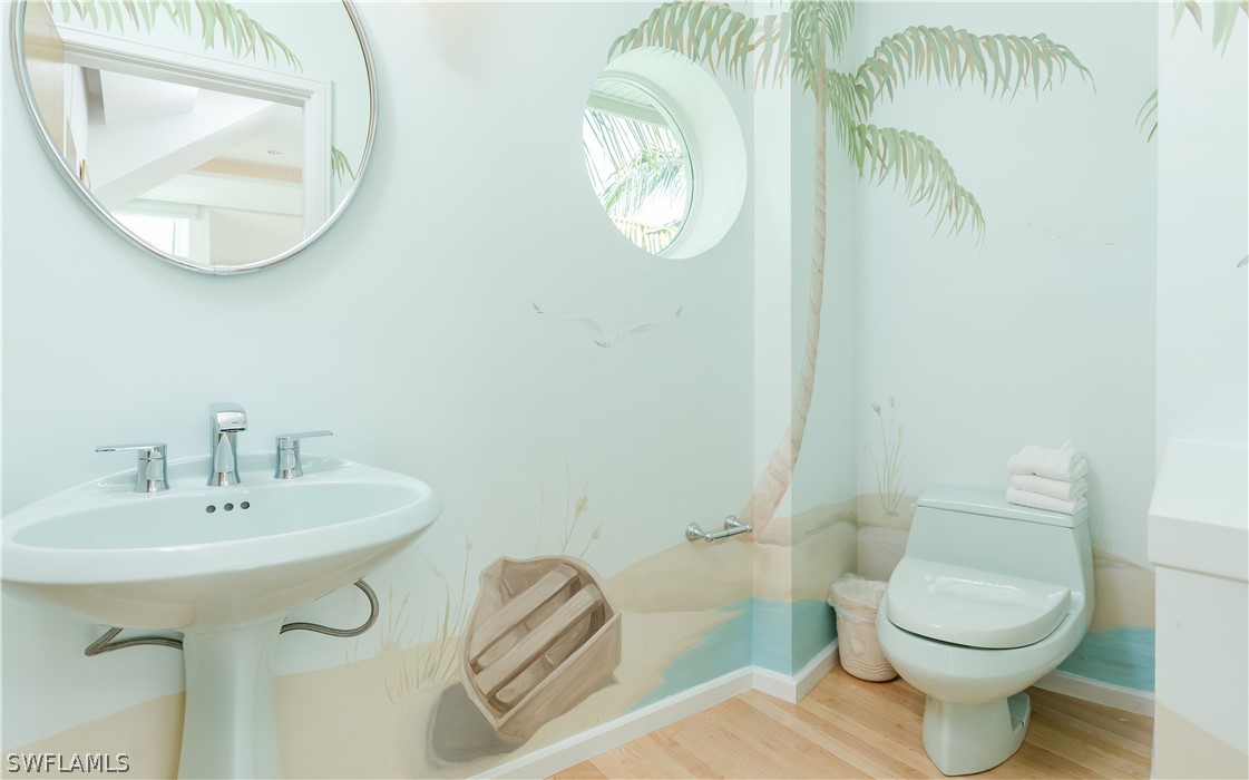 591 Rum Road Captiva, FL 33924 - Photo 9 of 34 a bathroom with a toilet a sink and a mirror