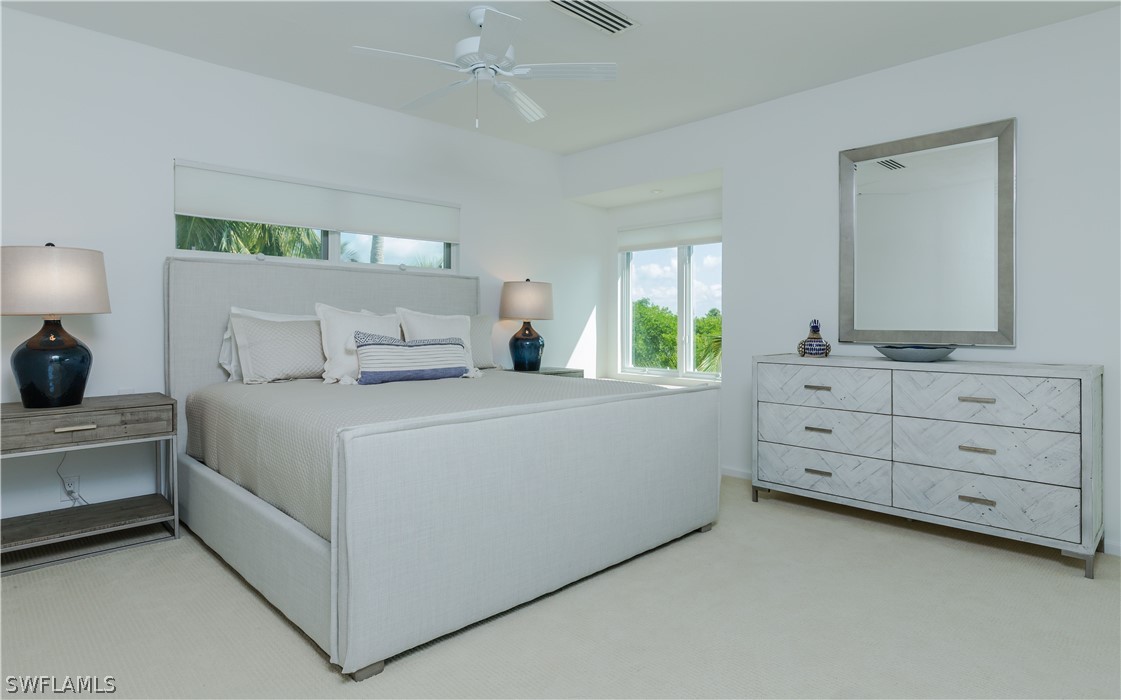 591 Rum Road Captiva, FL 33924 - Photo 10 of 34 a bedroom with a bed and a dresser
