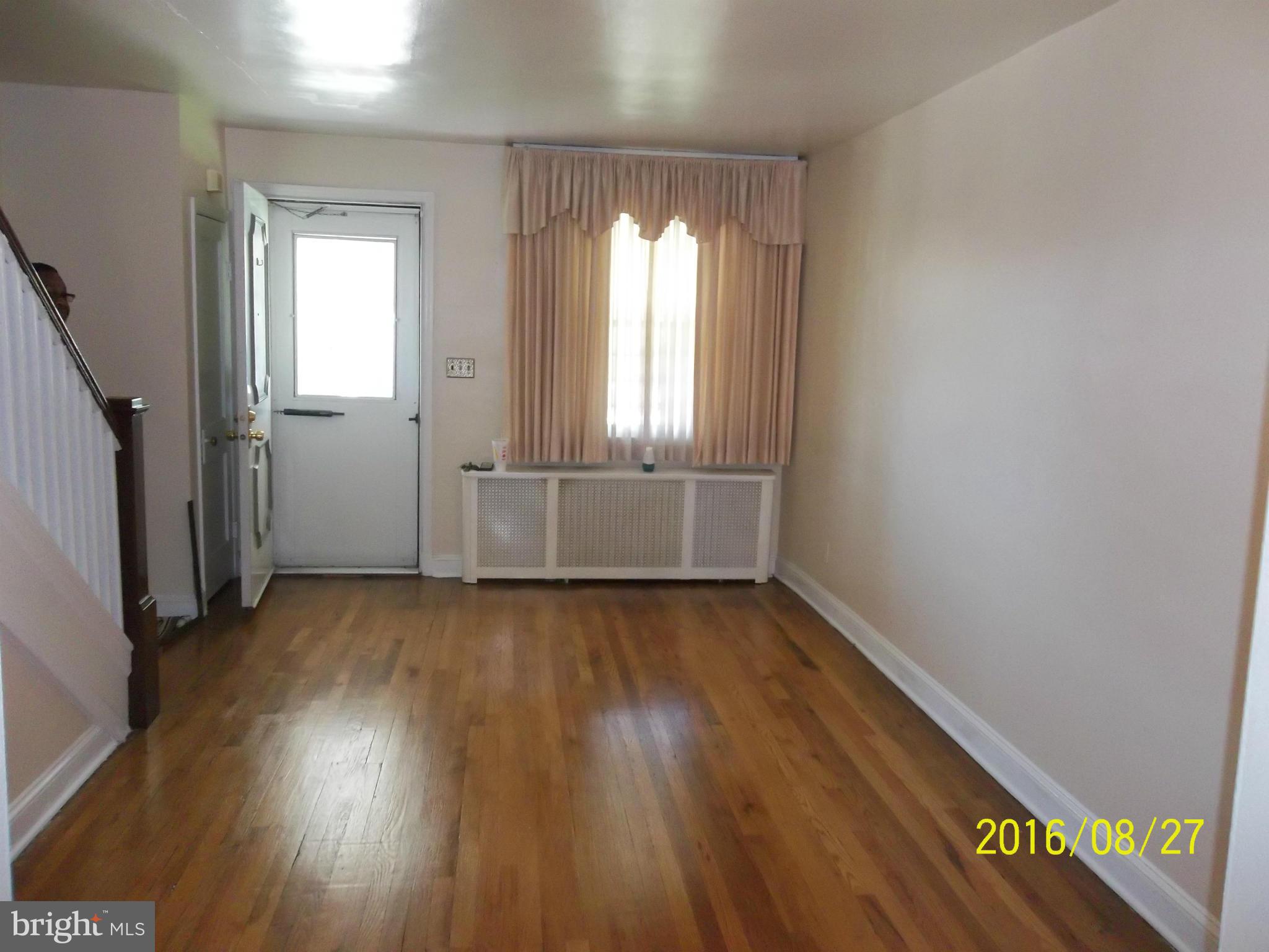 3810 Flowerton Road Baltimore, MD 21229 - Photo 2 of 20 an empty room with wooden floor and windows