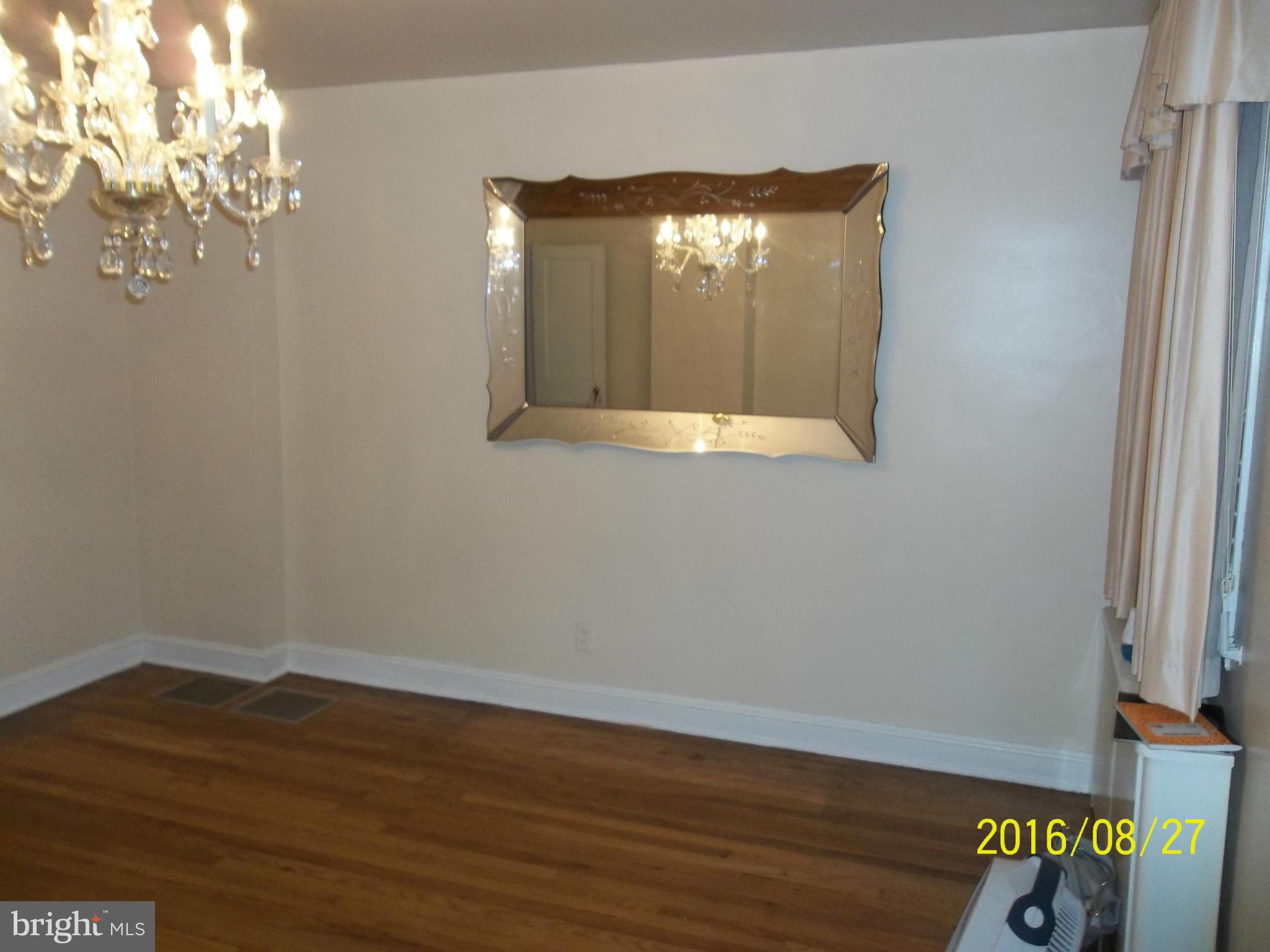 3810 Flowerton Road Baltimore, MD 21229 - Photo 3 of 20 an empty room with wooden floor and windows