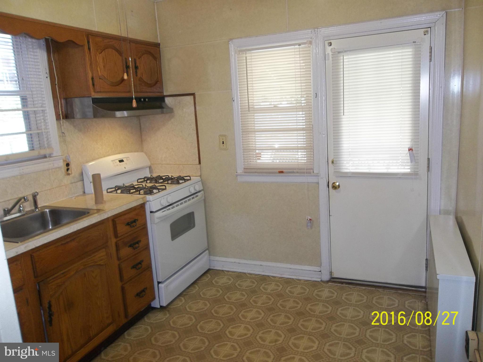 3810 Flowerton Road Baltimore, MD 21229 - Photo 4 of 20 a kitchen with stainless steel appliances a stove a sink and a refrigerator
