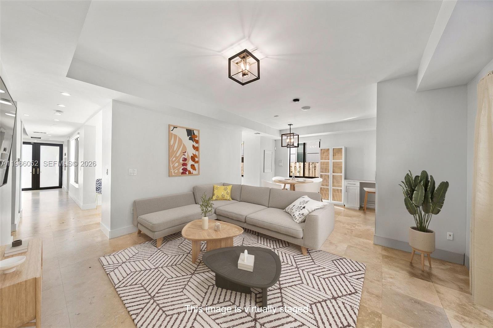6001 Southwest 28th Street Miami, FL 33155 - Photo 5 of 30 a living room with furniture a rug and a chandelier
