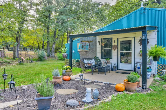 a backyard of a house with outdoor seating