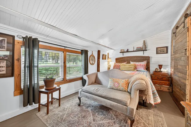 a bedroom with furniture and a window