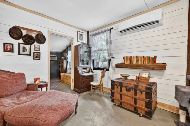 a bedroom with furniture and a lamp