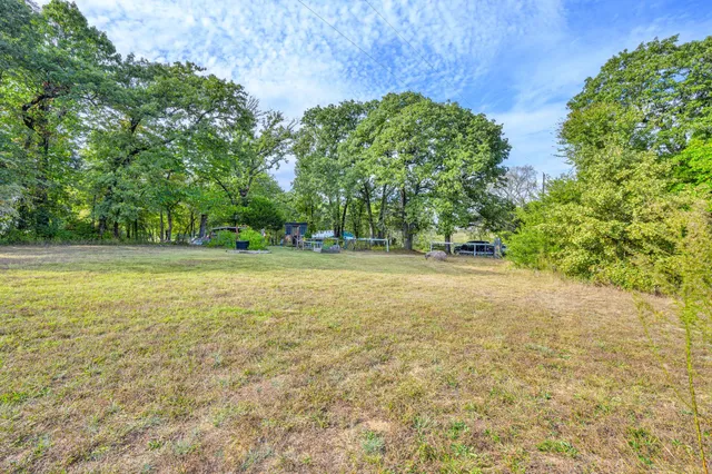 a view of outdoor space with trees all around
