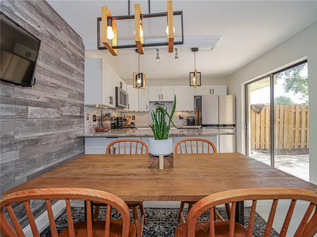 a view of a dining room with furniture window and outside view