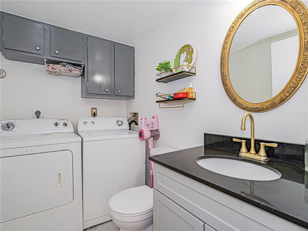 1170 6th Avenue, Unit 8B Vero Beach, FL 32960 - Photo 13 of 24 a bathroom with a sink a mirror and a toilet