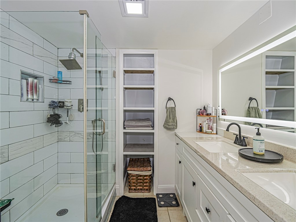 1170 6th Avenue, Unit 8B Vero Beach, FL 32960 - Photo 17 of 24 a bathroom with a double vanity sink a toilet and shower