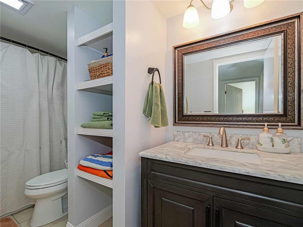1170 6th Avenue, Unit 8B Vero Beach, FL 32960 - Photo 18 of 24 a bathroom with a toilet sink and mirror