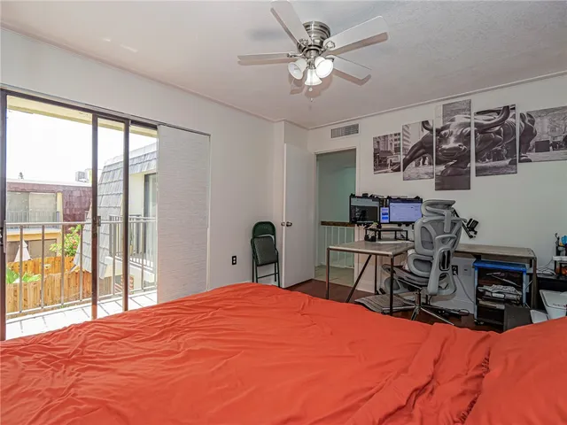 a bedroom with a large bed and a tv