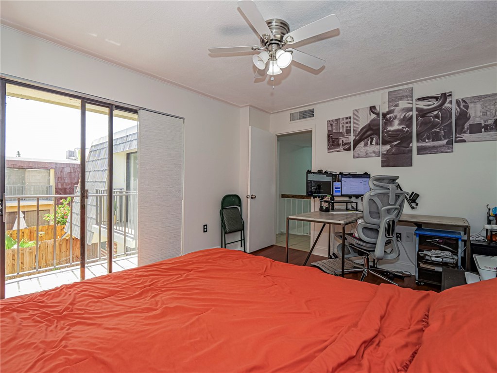 1170 6th Avenue, Unit 8B Vero Beach, FL 32960 - Photo 19 of 24 a bedroom with a large bed and a tv