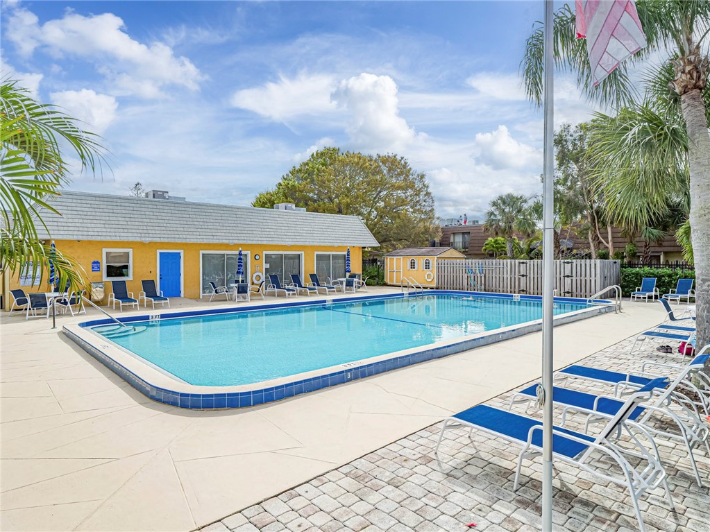 1170 6th Avenue, Unit 8B Vero Beach, FL 32960 - Photo 21 of 24 a view of a house with swimming pool and sitting area