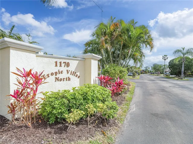 a sign that is in front of flowers