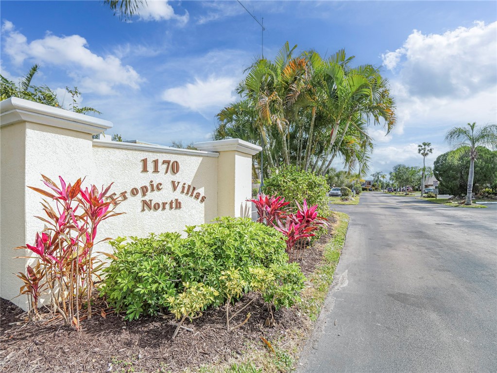 1170 6th Avenue, Unit 8B Vero Beach, FL 32960 - Photo 3 of 24 a sign that is in front of flowers