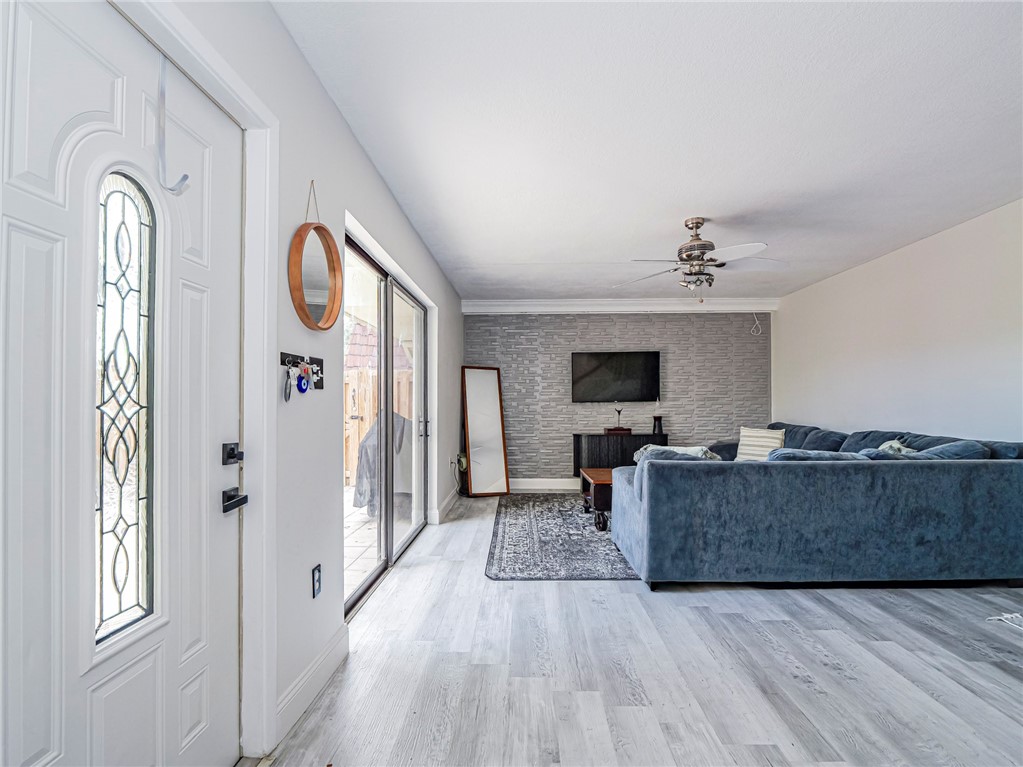 1170 6th Avenue, Unit 8B Vero Beach, FL 32960 - Photo 6 of 24 a living room with furniture and a flat screen tv