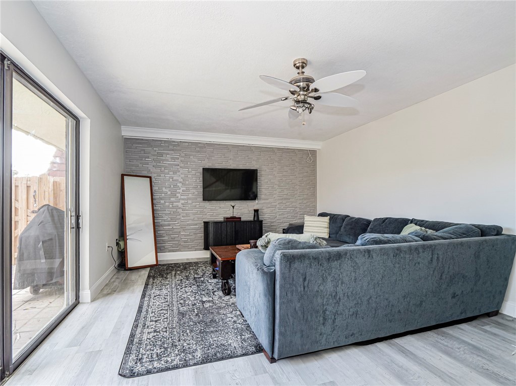 1170 6th Avenue, Unit 8B Vero Beach, FL 32960 - Photo 7 of 24 a living room with furniture and a flat screen tv