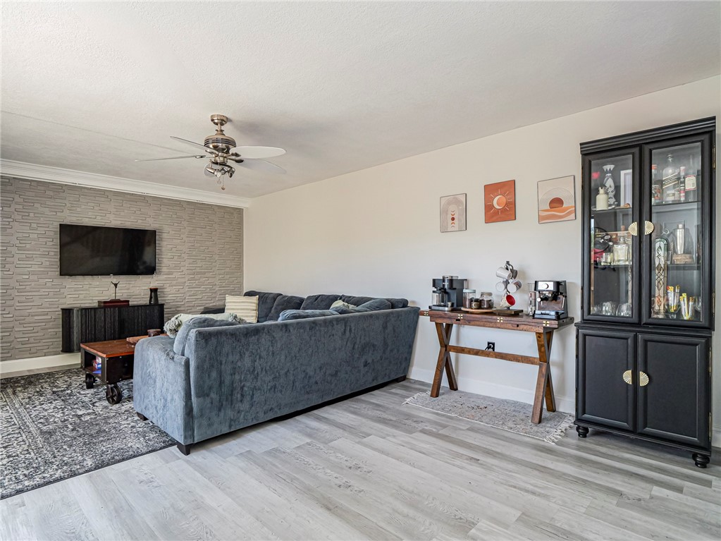 1170 6th Avenue, Unit 8B Vero Beach, FL 32960 - Photo 9 of 24 a living room with furniture and a flat screen tv