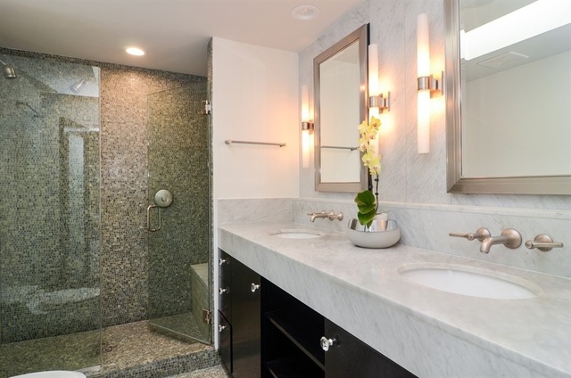 1014 West Grace Street Chicago, IL 60613 - Photo 19 of 24 a bathroom with a double vanity sink and a mirror