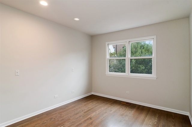 1014 West Grace Street Chicago, IL 60613 - Photo 23 of 24 an empty room with wooden floor and windows