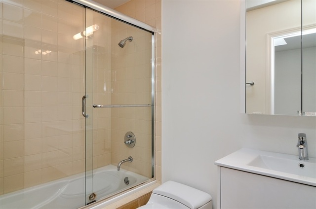 1014 West Grace Street Chicago, IL 60613 - Photo 24 of 24 a bathroom with a shower a sink a toilet and bathtub