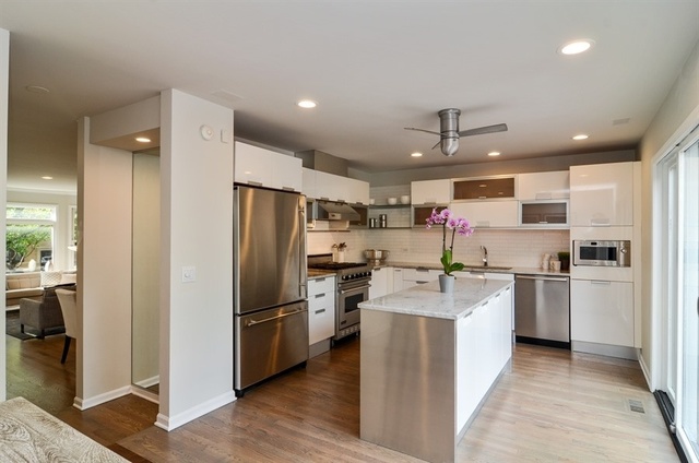 1014 West Grace Street Chicago, IL 60613 - Photo 7 of 24 a kitchen with stainless steel appliances granite countertop a refrigerator oven a sink dishwasher and white cabinets with wooden floor