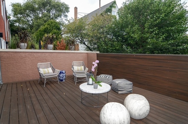 1014 West Grace Street Chicago, IL 60613 - Photo 9 of 24 a backyard of a house with table and chairs