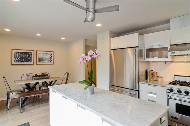 1014 West Grace Street Chicago, IL 60613 - Photo 10 of 24 a kitchen with stainless steel appliances granite countertop a refrigerator a stove a sink a dining table and chairs with wooden floor