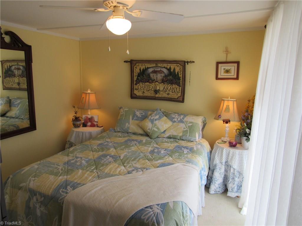 2136 Riverview Rd Extension Lexington, NC 27292 - Photo 23 of 28 The Master Bedroom is cozy and plenty of light from the sliding door to the deck.
