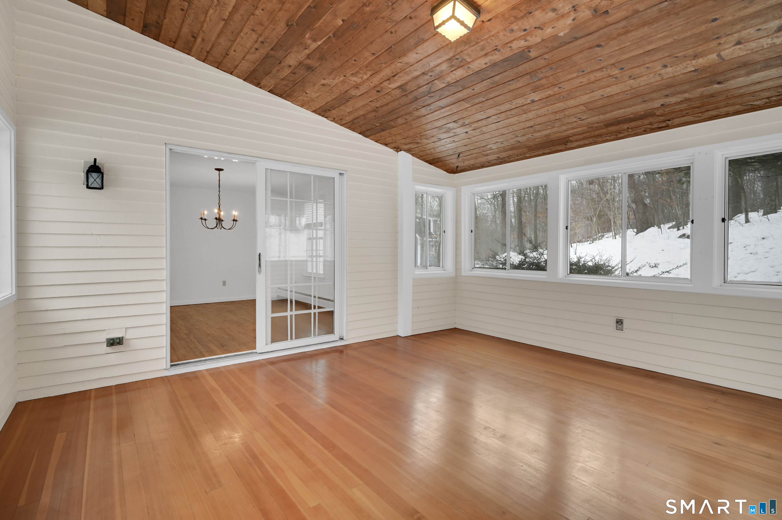 743 Green Hill Road Madison, CT 06443 - Photo 15 of 39 a view of an empty room with wooden floor and a window