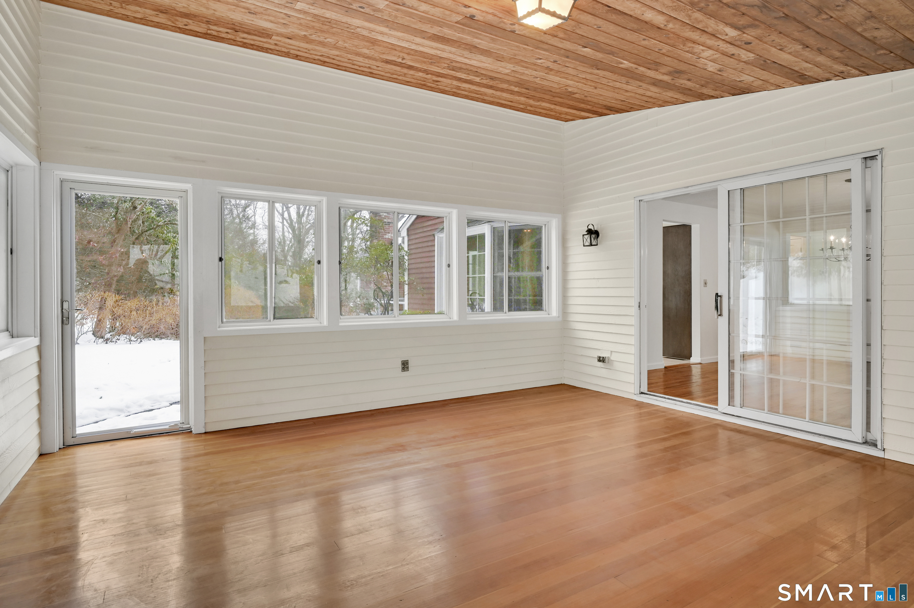 743 Green Hill Road Madison, CT 06443 - Photo 16 of 39 an empty room with wooden floor and windows