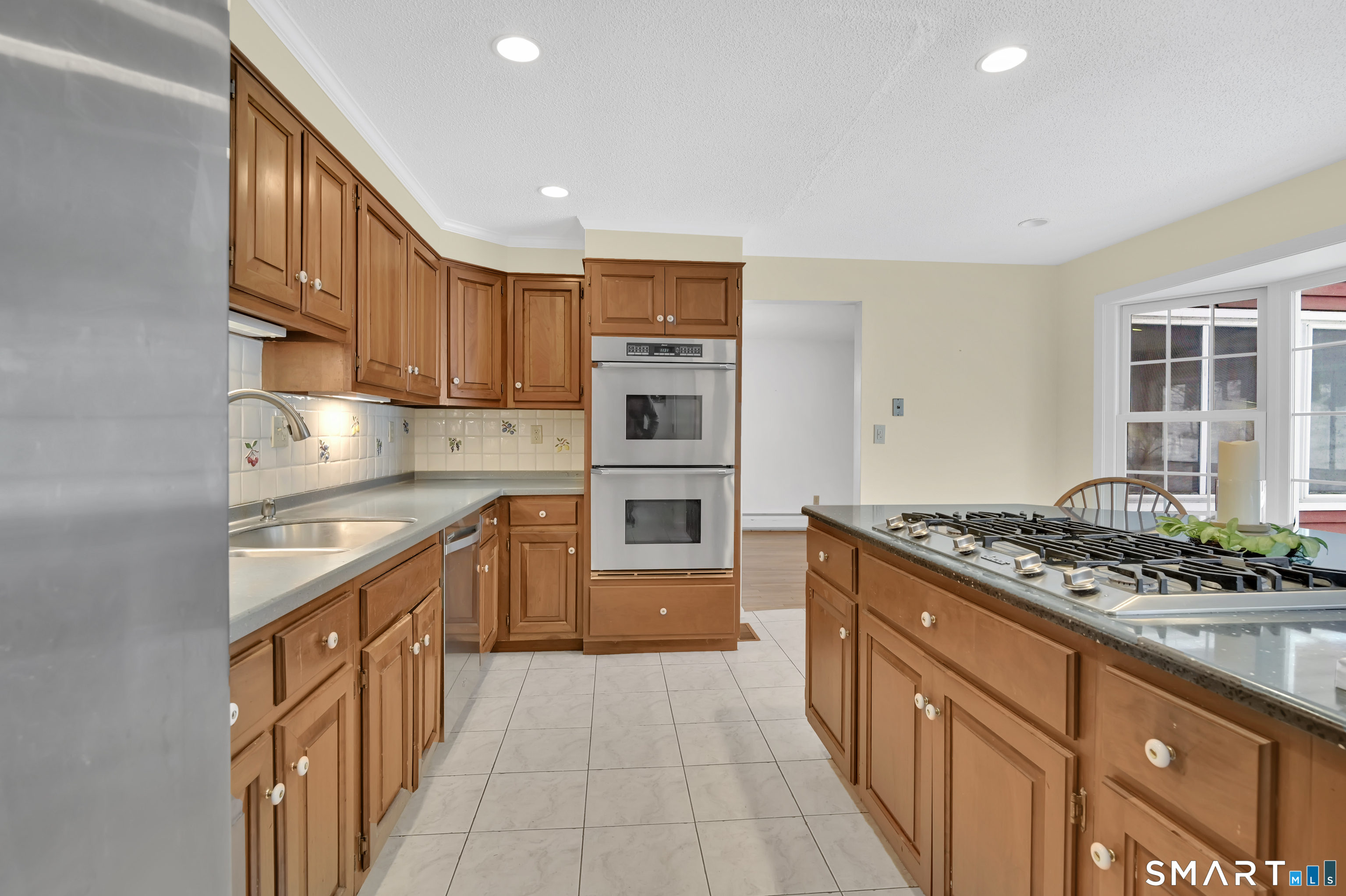 743 Green Hill Road Madison, CT 06443 - Photo 19 of 39 a kitchen with stainless steel appliances granite countertop a stove and a refrigerator