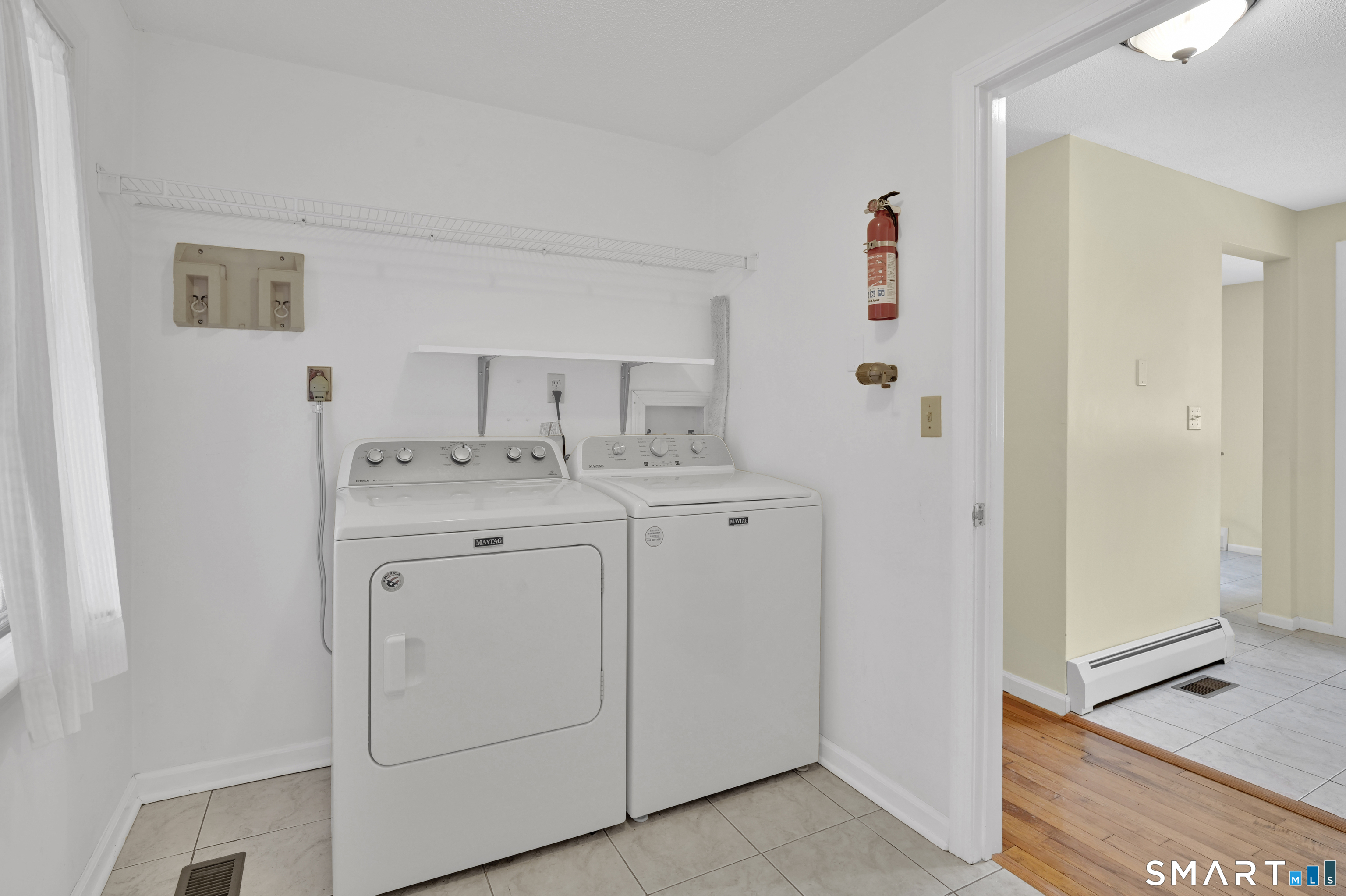 743 Green Hill Road Madison, CT 06443 - Photo 21 of 39 a utility room with cabinets washer and dryer