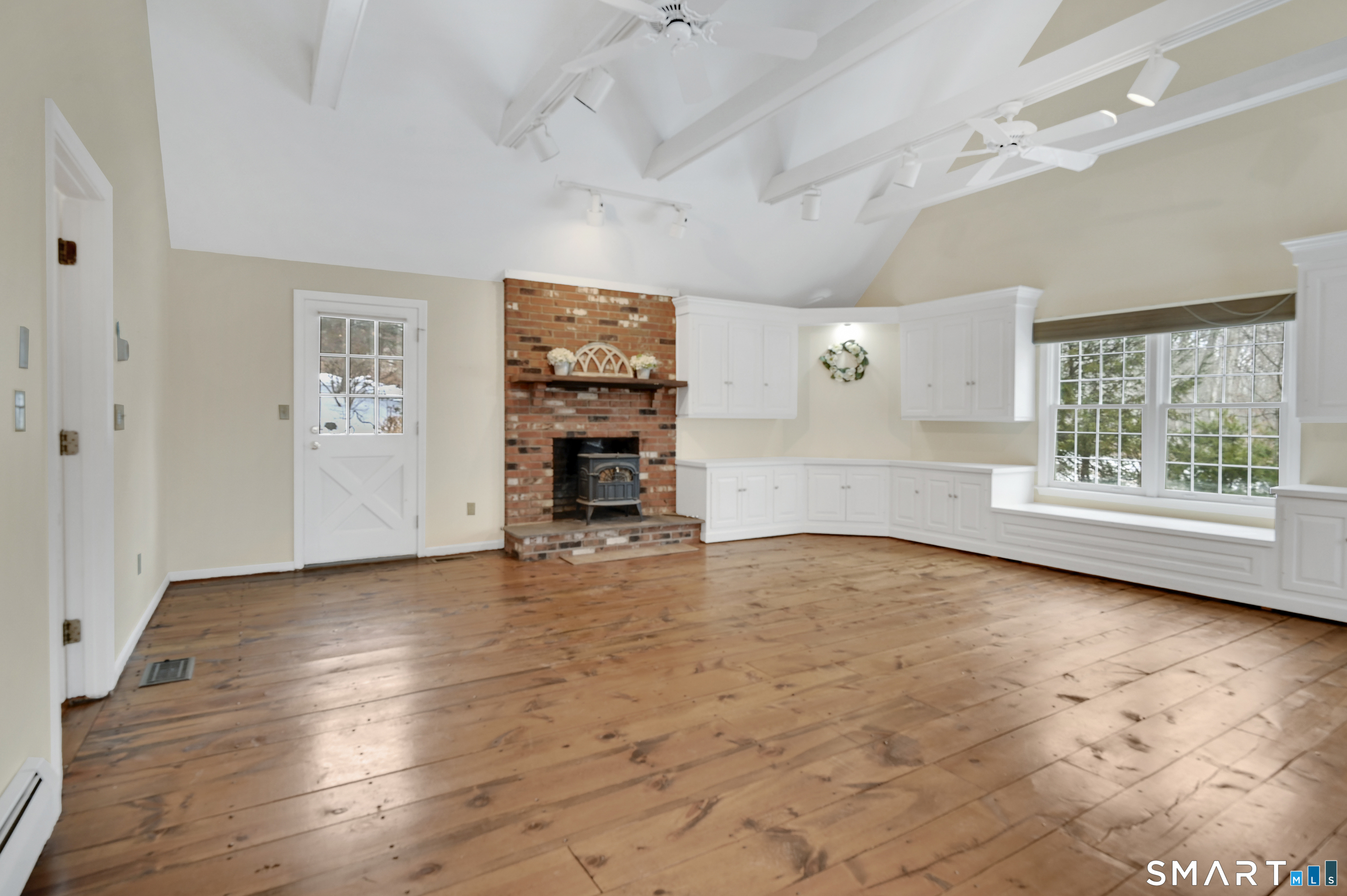 743 Green Hill Road Madison, CT 06443 - Photo 24 of 39 an empty room with windows and fireplace