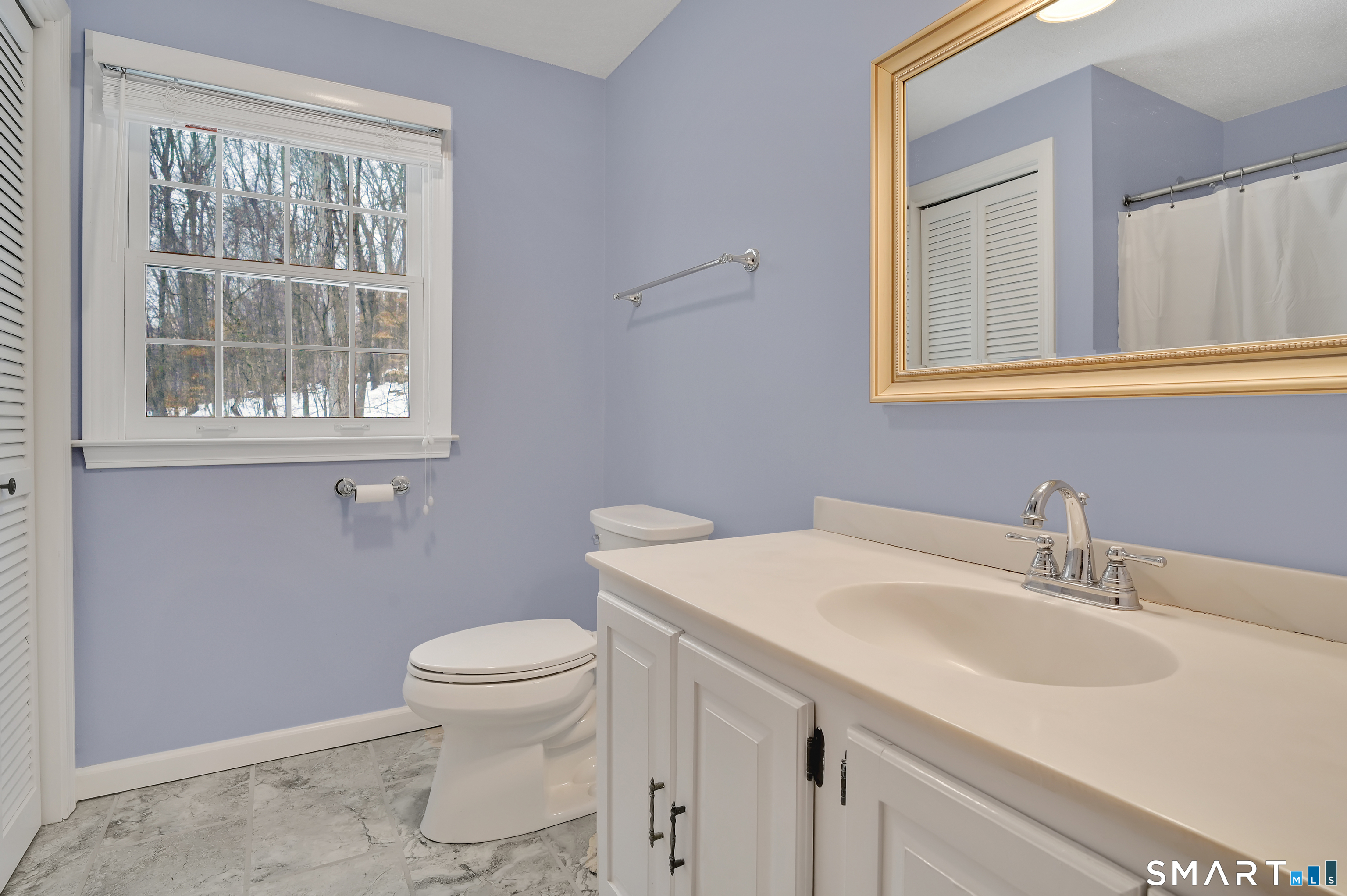 743 Green Hill Road Madison, CT 06443 - Photo 30 of 39 a bathroom with a sink a toilet and a window
