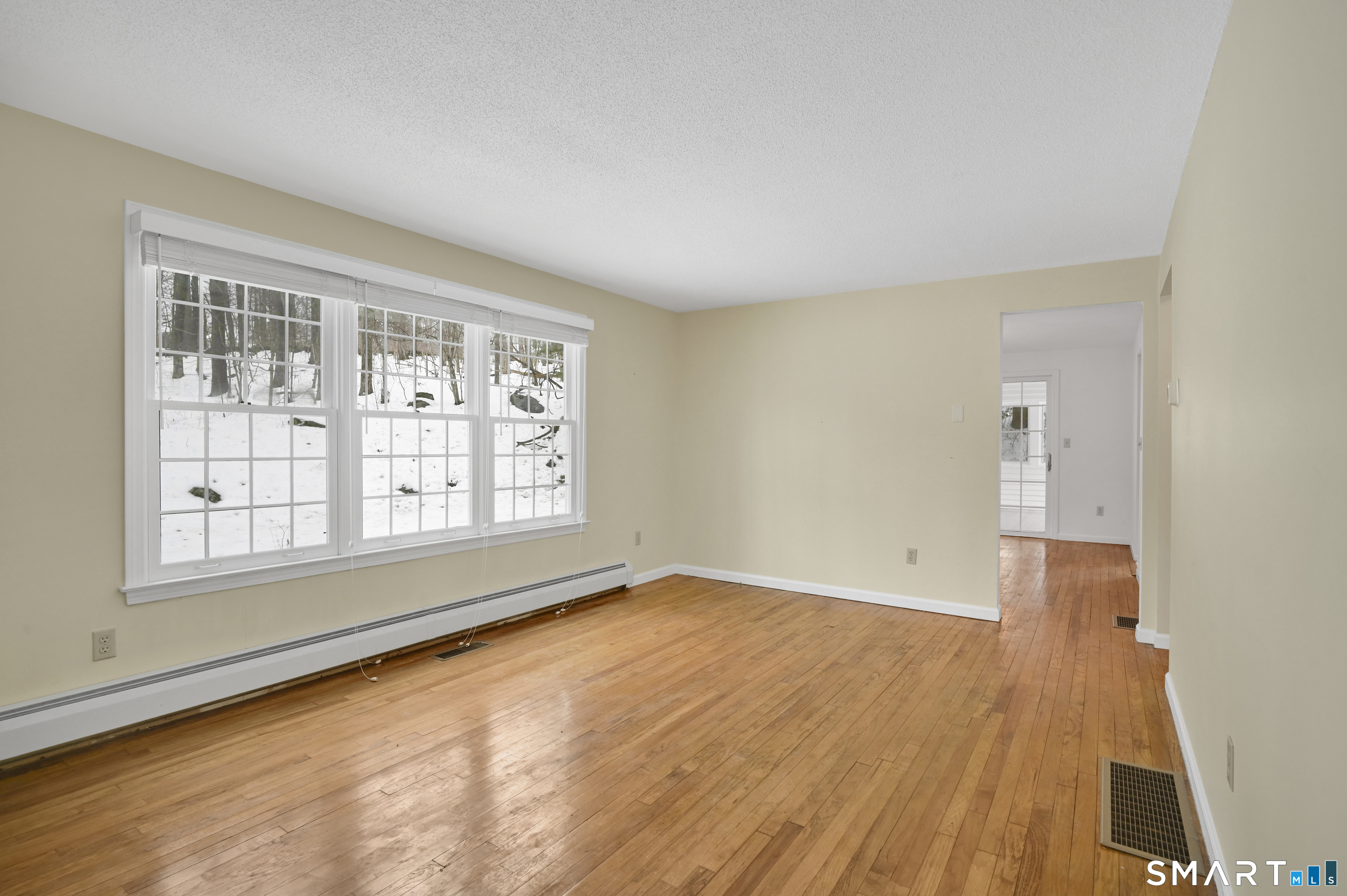 743 Green Hill Road Madison, CT 06443 - Photo 10 of 39 an empty room with wooden floor and windows