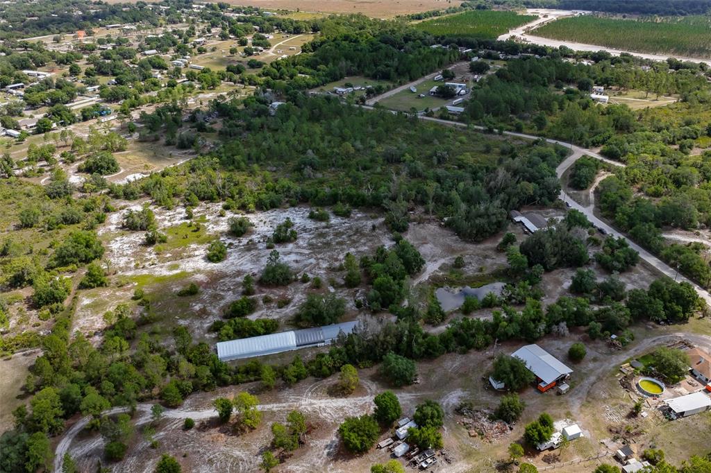 14451 Highland Road Wimauma, FL 33598 - Photo 78 of 80 an aerial view of residential houses with outdoor space and trees