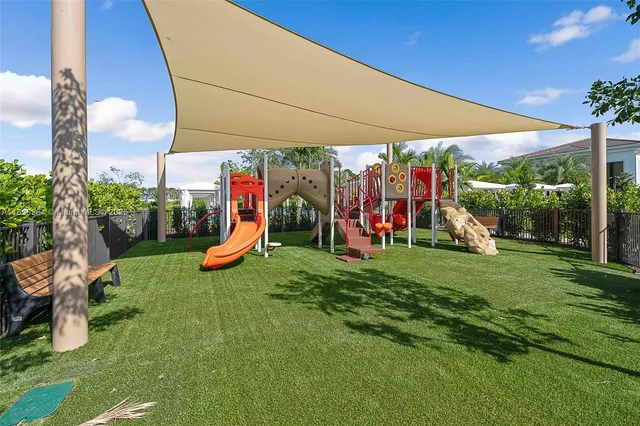 a view of a park with furniture and a slide