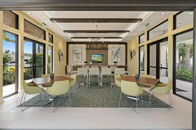 a view of a dining room with furniture wooden floor and a chandelier