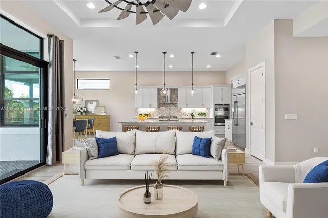 a living room with furniture and kitchen view