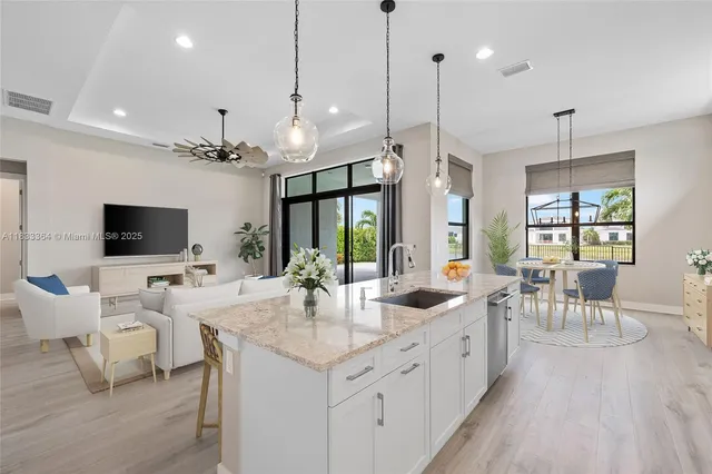 a large kitchen with a table and chairs