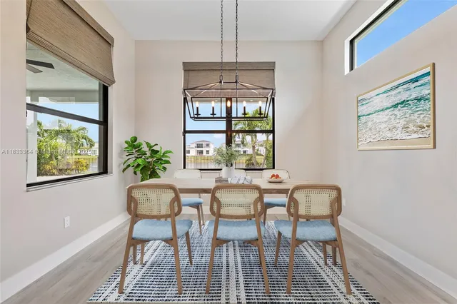 a dining room with furniture a rug and a chandelier