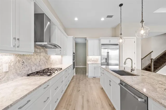a kitchen with granite countertop a sink stove and cabinets